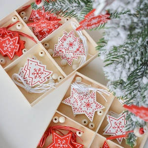 Christmas wooden tree and star pendants in red and white colors stored in a wooden box
