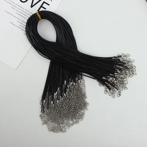 Detailed view of black waxed necklace cords with silver lobster clasps and extension chains