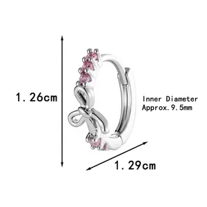 Silver bow hoop earrings with pink cubic zirconia and size dimensions of 1.26cm by 1.29cm