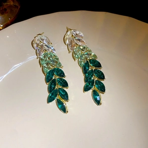 Long dangle earrings with marquise-cut green crystals and gold leaf arrangement