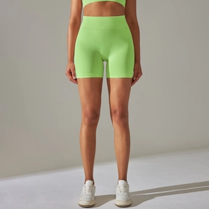 Detailed close-up of neon green high-waisted seamless ribbed gym shorts for women