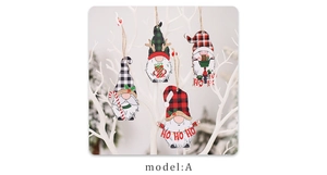 Detailed view of four wooden Christmas gnome ornaments with plaid hats and candy canes
