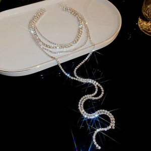 Luxurious layered silver fringe necklace with shimmering rhinestones and starburst effect