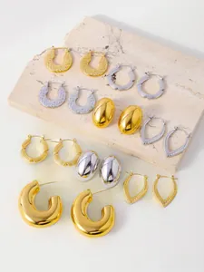 Macro shot of gold and silver geometric earrings with polished and hammered textures