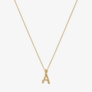 Macro detail of gold S925 silver letter A pendant with lava texture and zircon stones