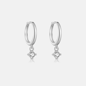 Detail of silver S925 geometric hoop earrings with sparkling round zircon drop pendants