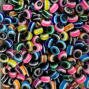 Macro view of colorful resin evil eye beads for DIY jewelry making and crafts