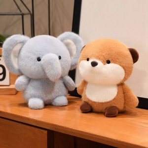 Cute plush elephant and forest animal dolls on a warm wooden surface for home decor