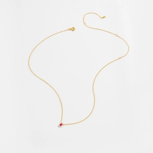 Detailed close-up of a S925 silver necklace with a red pear-shaped gemstone drop pendant