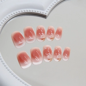 French tip cat eye press-on nails with pink blush gradient and white flower designs