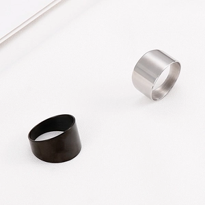 Detail of minimalist wide titanium steel rings in silver and black with a matte finish