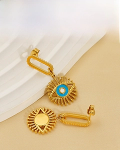 Detail of 18K gold-plated devil's eye earrings with blue enamel and sunburst design