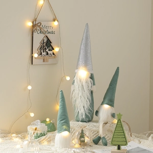 Lighted Christmas gnomes set with green and silver hats for festive tabletop decoration