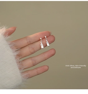 Close-up of S925 sterling silver animal shaped earrings with a unique matte brushed texture
