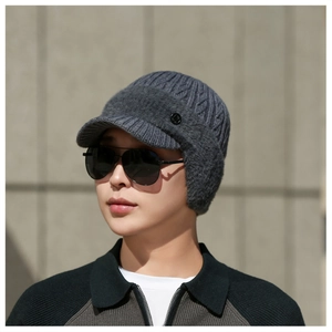Detailed view of the dark grey knitted winter hat with fleece lining and ear protection