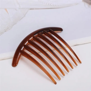 Brown translucent curved hair comb with nine teeth on a clean white background