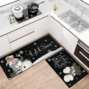 Two-piece Christmas kitchen rug set with snowman and snowflake prints in a modern white kitchen