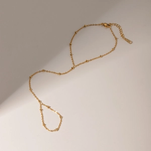 Minimalist 18k gold plated stainless steel bead chain ring bracelet set on white background