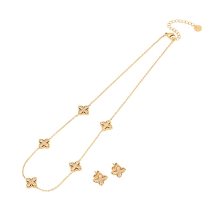 Gold floral necklace and earrings set with crystal stones and faux pearls on white background
