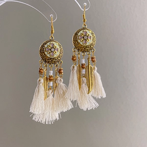 Boucles d'oreilles fleurs dorées vintage avec émail et élégants pompons blancs