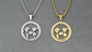 Close-up of gold and silver couple necklaces with pavé diamond boy and girl pendants