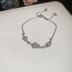 Macro detail of silver-tone gourd bracelet with white pearls and sparkling zircons