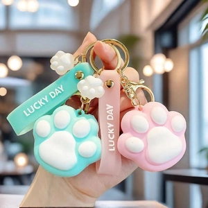Cute pink and mint green silicone cat paw keychains with Lucky Day wrist straps