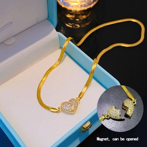 Golden heart necklace with diamonds featuring a magnetic opening and snake chain
