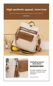 Macro detail of the leather fringe zipper pulls on the beige and brown backpack