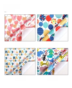 Detail of eco-friendly gift wrap featuring hearts, balloons, and Happy Birthday patterns