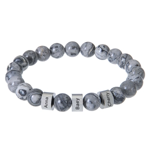 Close-up of personalized grey marble beads bracelet with engraved silver name cylinders