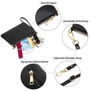 Minimalist black lychee leather crossbody bag with gold zippers and adjustable strap