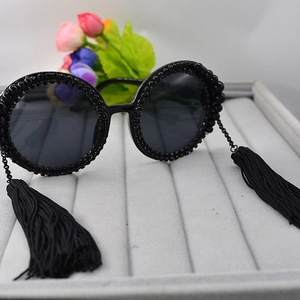 Retro round oversized sunglasses for women featuring black beads and long fringe tassels