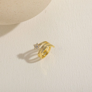 Detailed macro view of multi-layer 14K gold plated ring with star-shaped zircon stones
