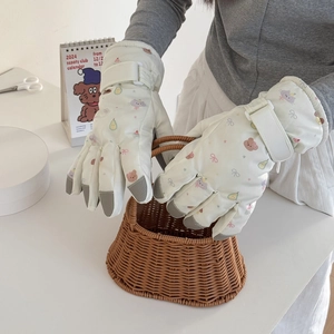 Detail of cute cartoon ski gloves featuring non-slip grip pads and adjustable wrist straps
