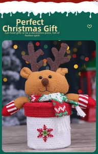 Detailed view of a Christmas reindeer gift jar with festive knitted scarf and snowflake patterns