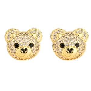 Macro detail of gold teddy bear earrings with pavé set sparkling crystal zircons