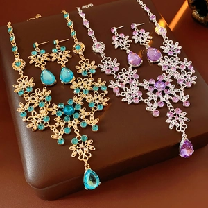 Detail of vintage flower jewelry sets with teardrop gems in gold and silver finish