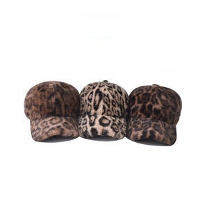 Detailed view of leopard print baseball caps in thick faux fur material for winter warmth