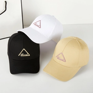 Three cotton baseball caps in black, white, and khaki with triangular embroidered patches