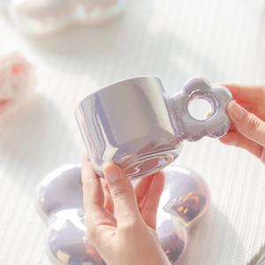 Macro detail of a purple pearlescent macaron flower ceramic coffee cup and saucer set