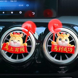 Close-up of cute cartoon pig car air vent clips with red spinning fans in the car