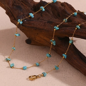 18K gold plated stainless steel necklace with irregular blue turquoise stones on wood