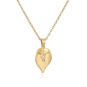 Minimalist gold leaf pendant necklace with shimmering zircon on a polished O-chain