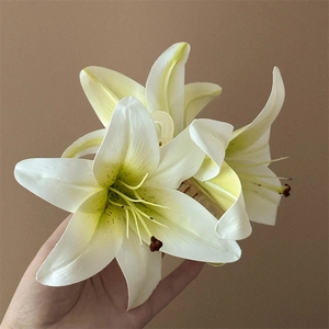 Macro view of lifelike white artificial lily hair claw clip with yellow gradients