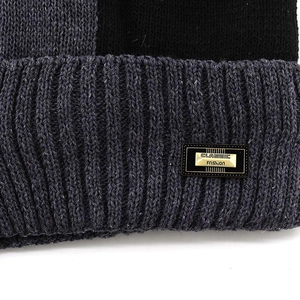Mens knit balaclava hat featuring grey-black stitching and metallic logo tag