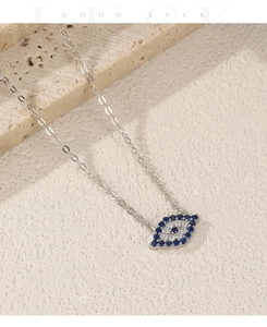 Macro detail of S925 sterling silver evil eye pendant necklace on stone surface