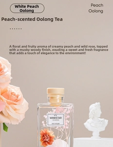 Peach Oolong reed diffuser detail with dried flowers, roses and plaster statue décor