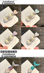 Close-up of pastel macaron heart hair clips with pearlescent resin and glitter detail