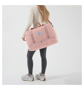 Detail of pink sports bag featuring star embossed stitching and separate shoe compartment